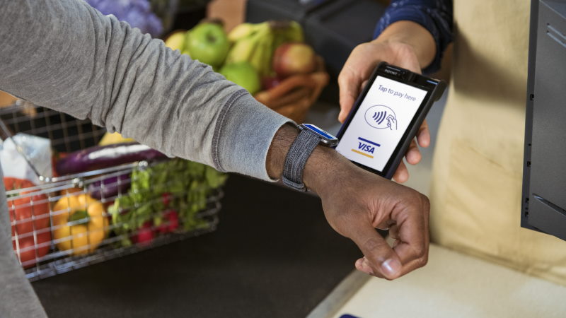 Man paying with contactless enabled watch