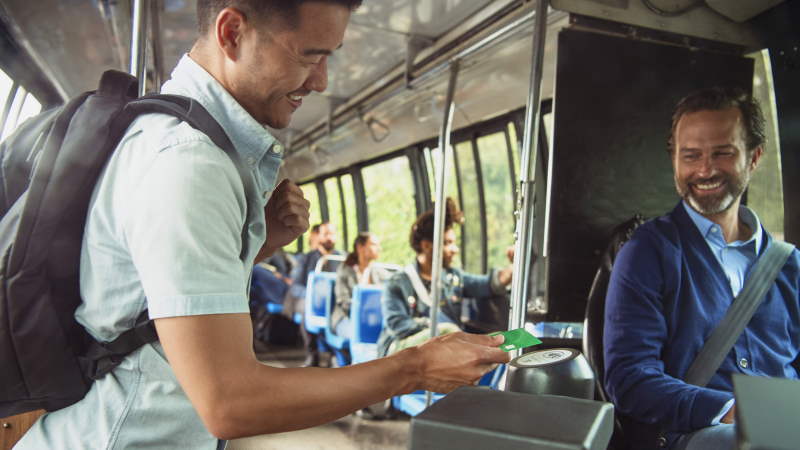 Man paying with contactless card on bus