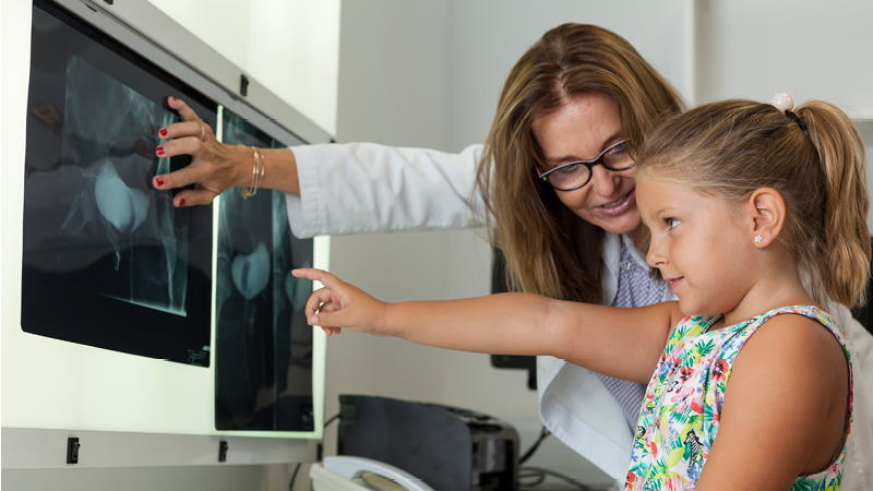 Doctor showing girl an x-ray